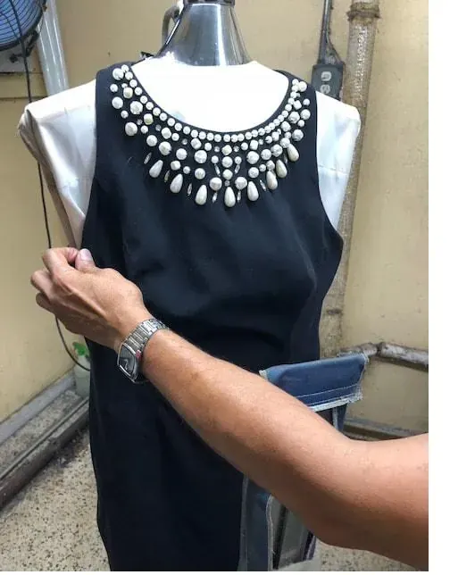Dress on a hanger after alterations at Frankie's Cleaners