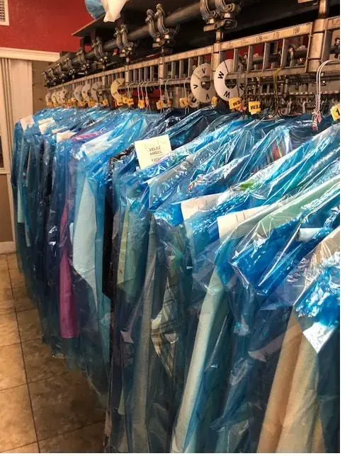Rack of freshly cleaned garments in protective covers